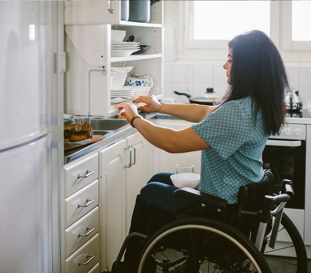 Kitchen home modification with woman in a wheelchair
