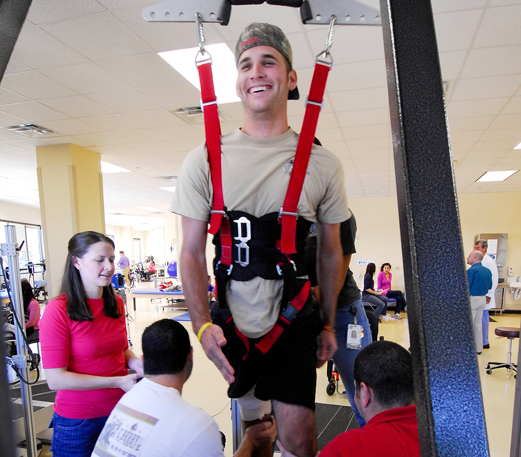 man using locomotor training harness