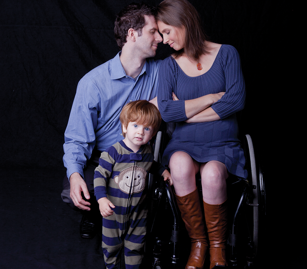 Photo of a family, man, woman wheelchair user, and a small child