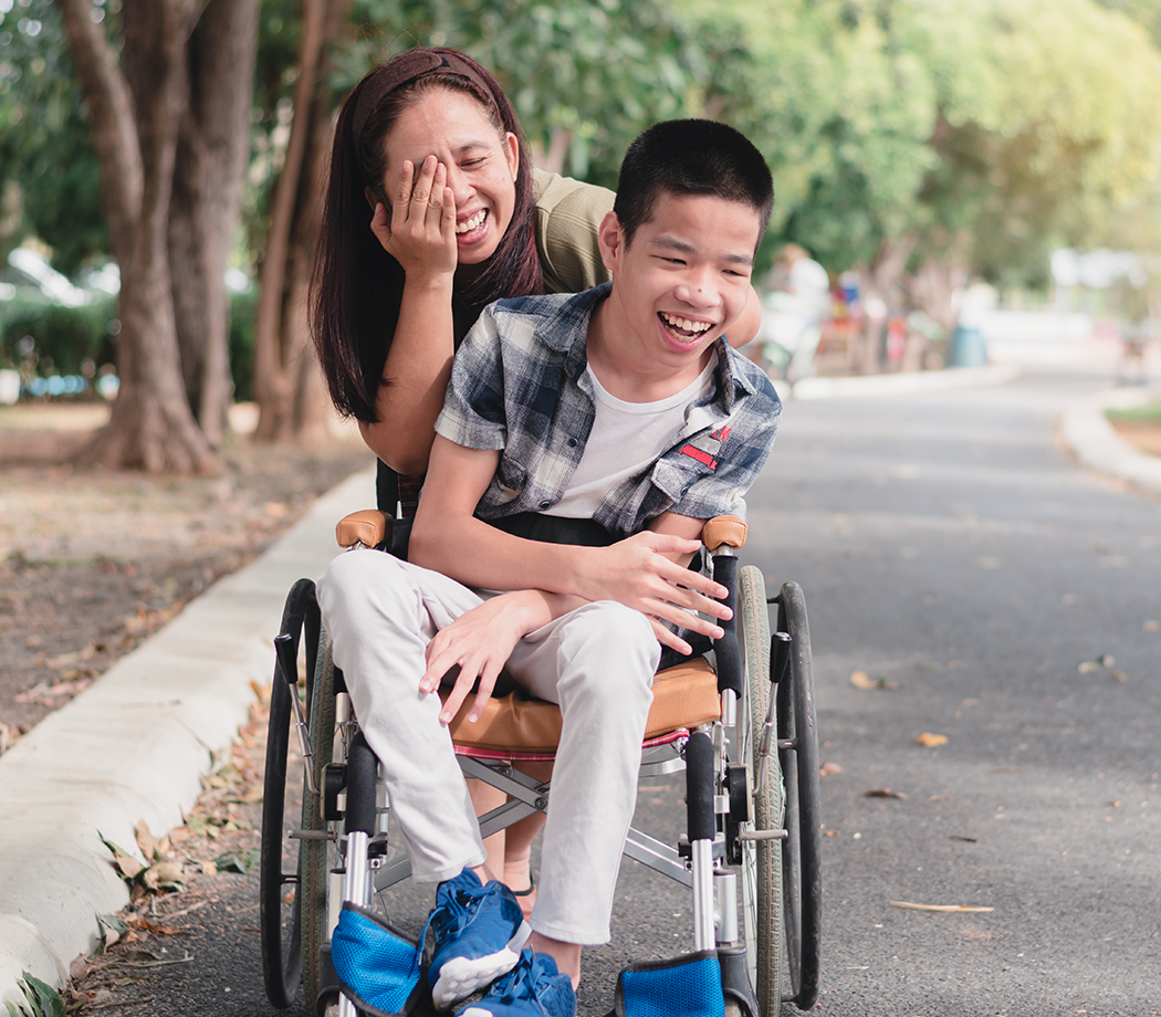 Woman with a young male wheelchair user.
