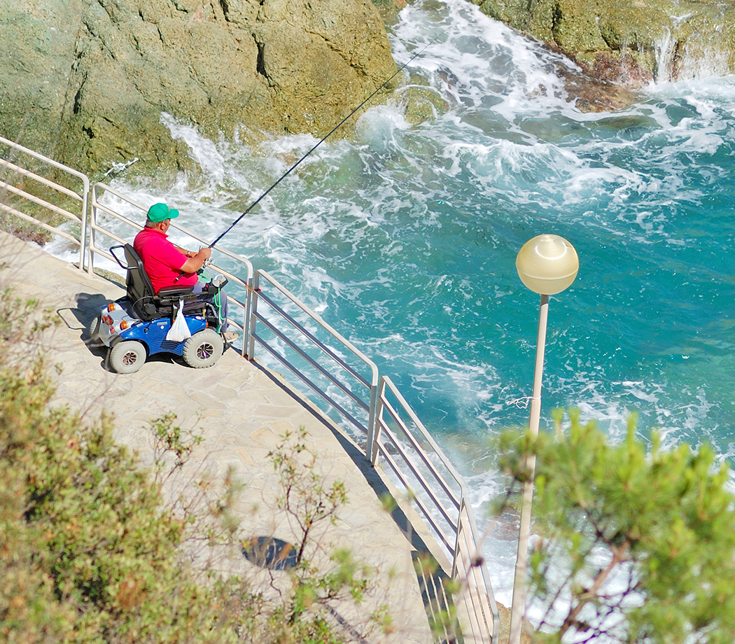 Man in power wheelchair fishing