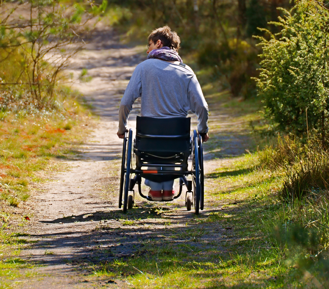 Wheelchair user on an outdoor trail.