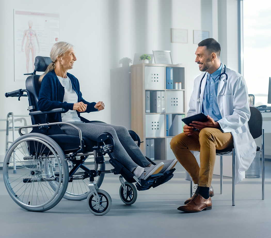Hospital Physical Therapy: Strong Senior Female in Wheelchair, Talks to a Friendly Rehabilitation