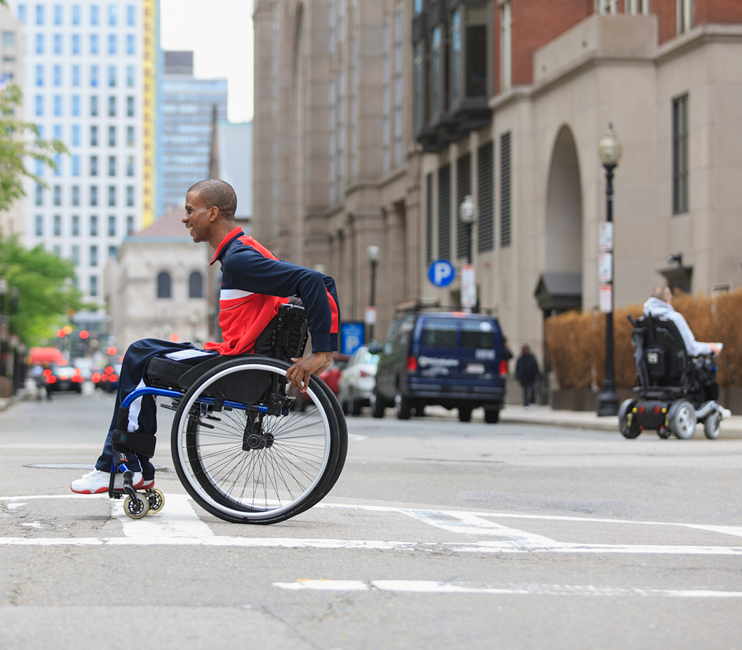 Man in wheelchair crossing the street