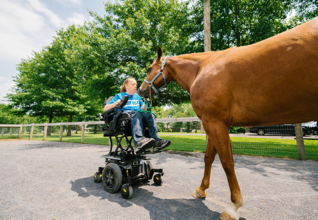 Christina in a wheelchair with a horse